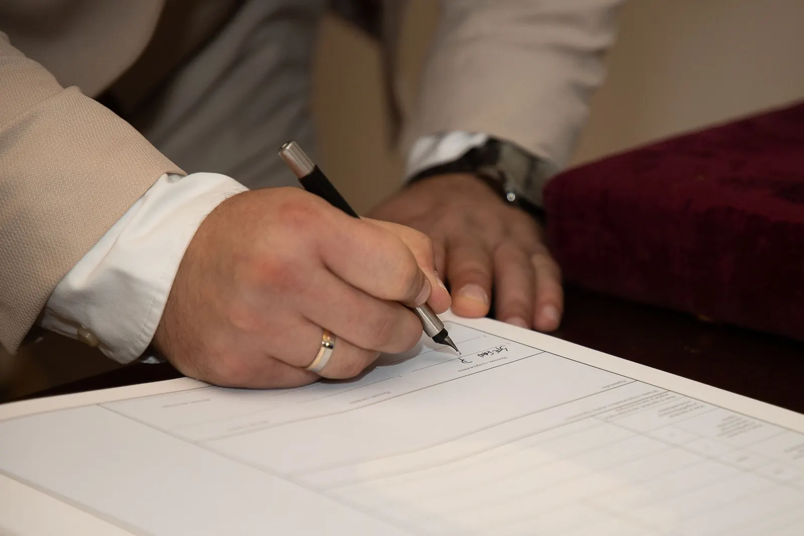 Groom signing a marriage document