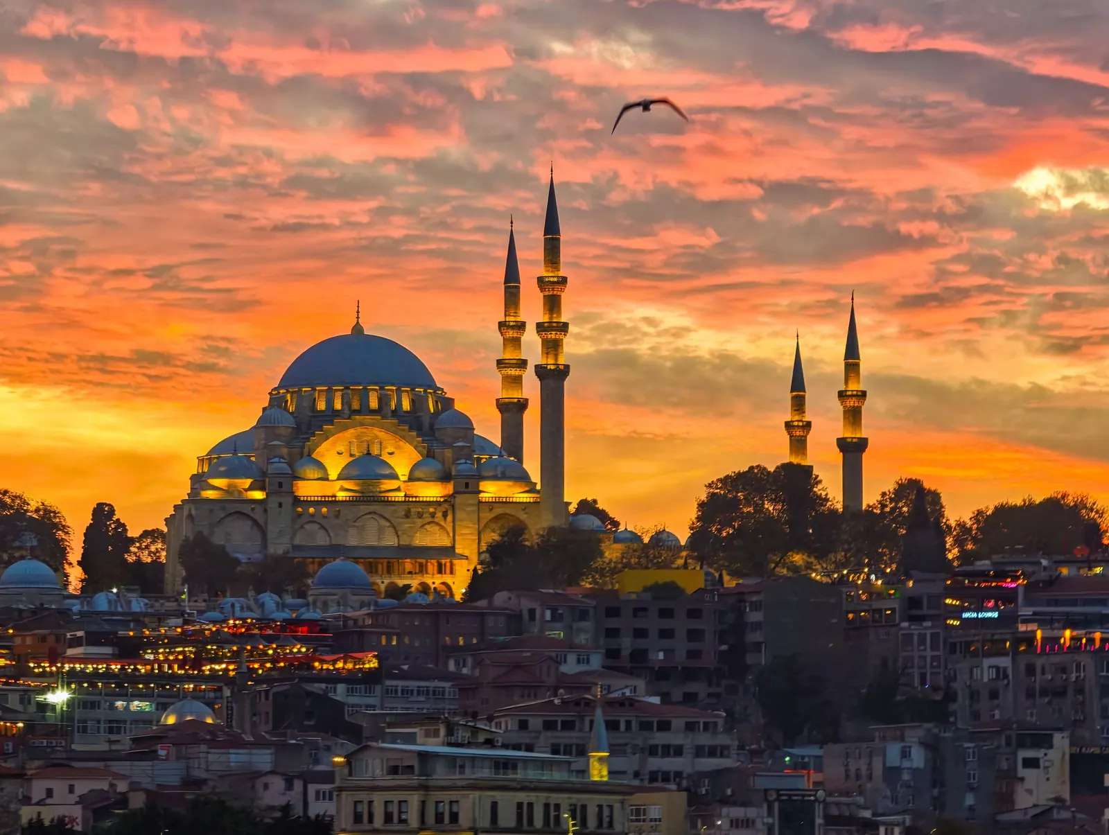 Mosque and minarets under a golden sunset sky