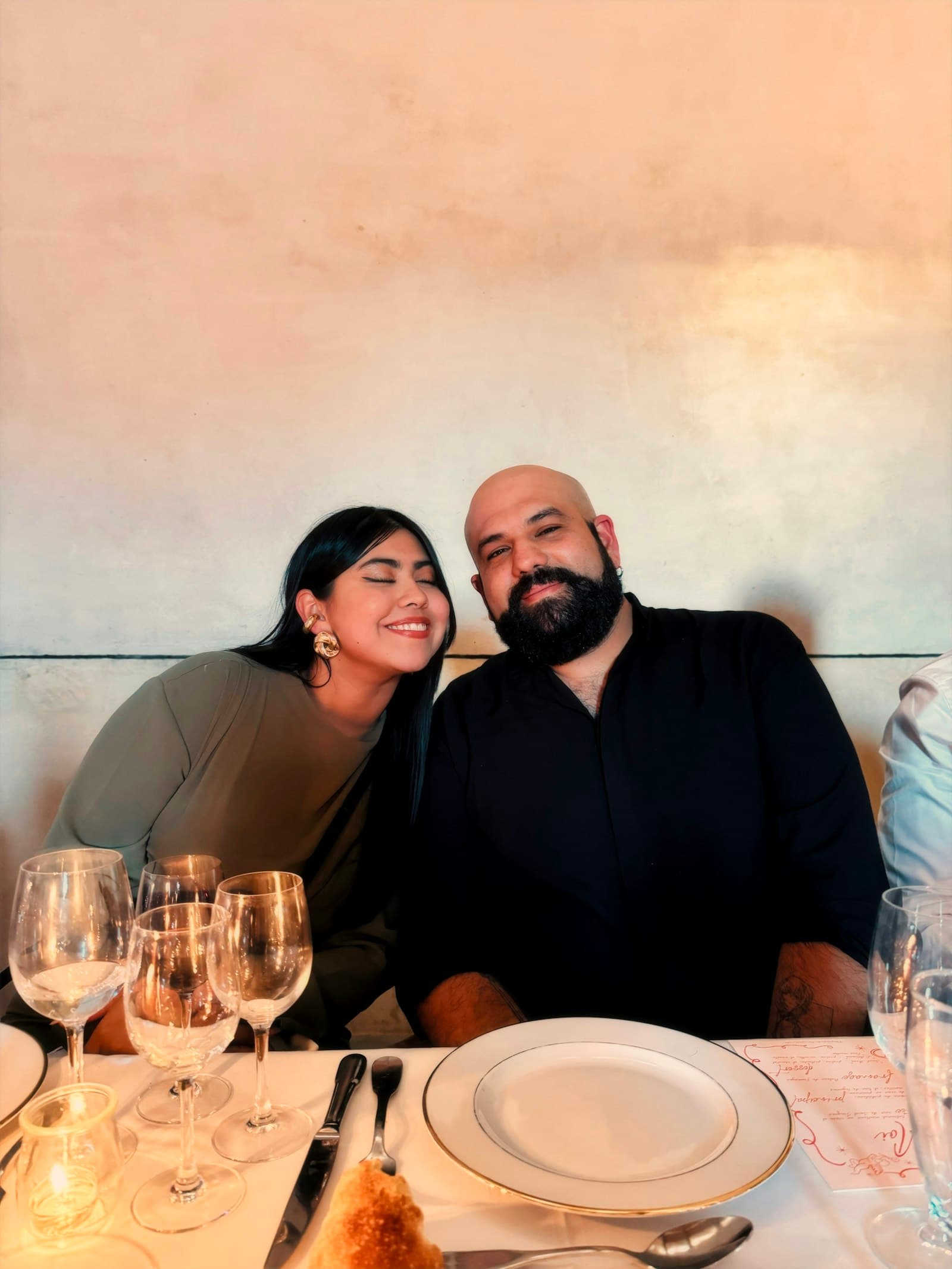 A couple sitting close together, smiling