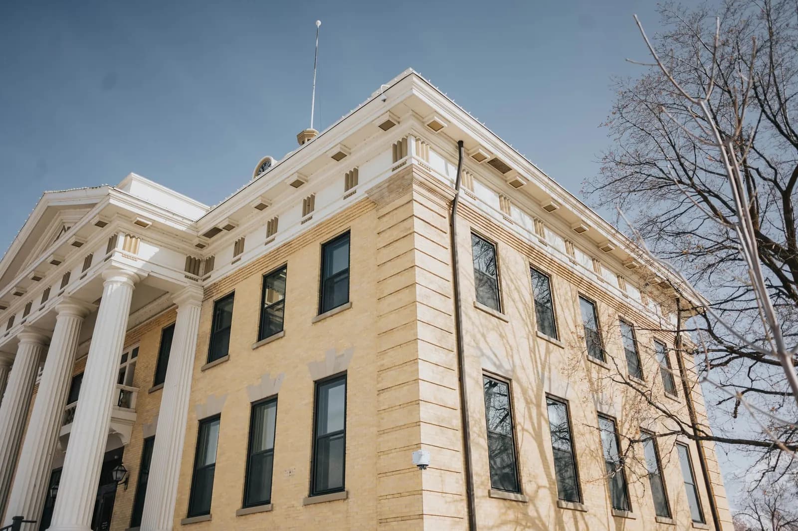 Front of a county courthouse building seen from a low angle.