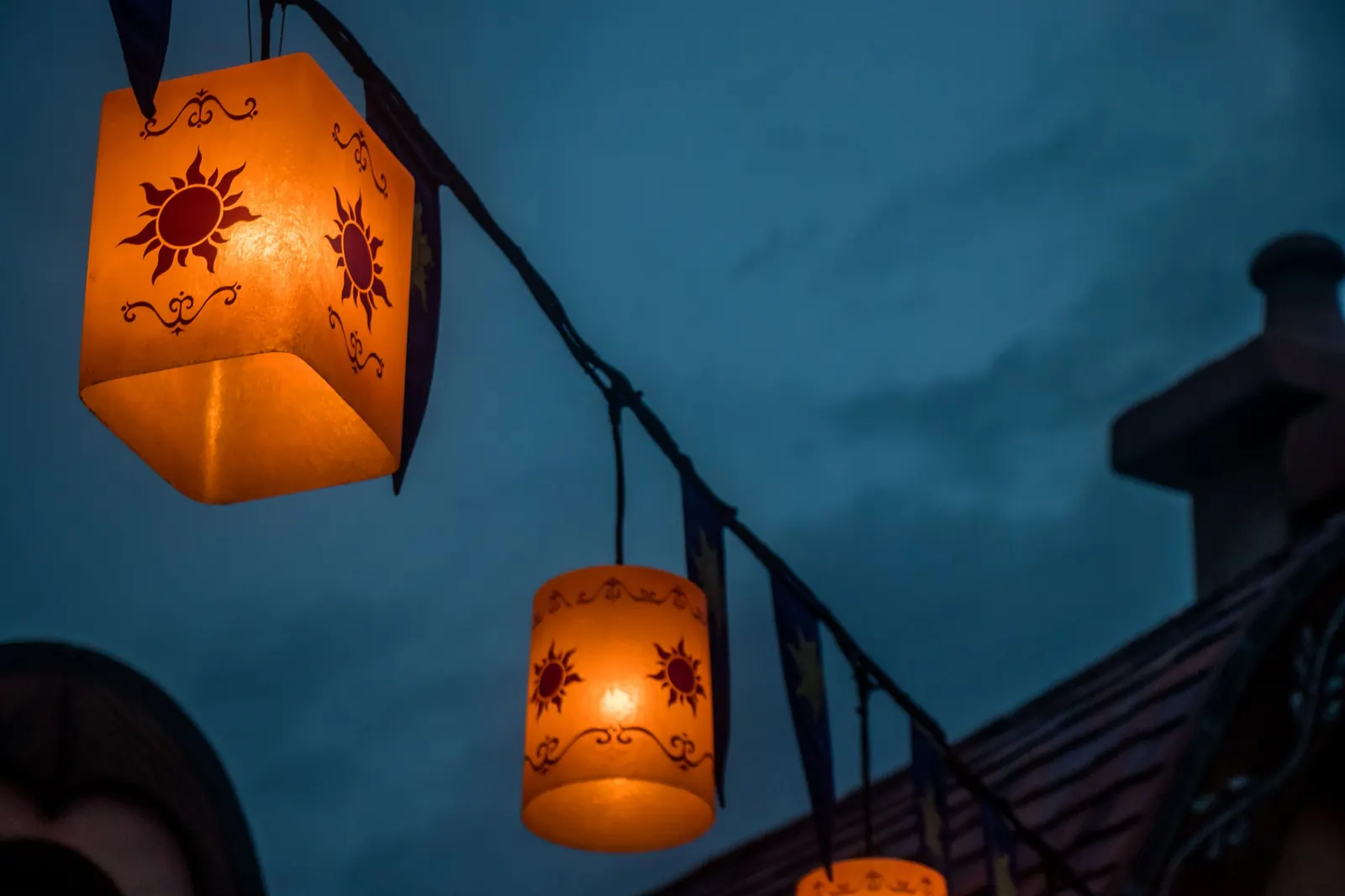 Glowing lanterns against an evening sky