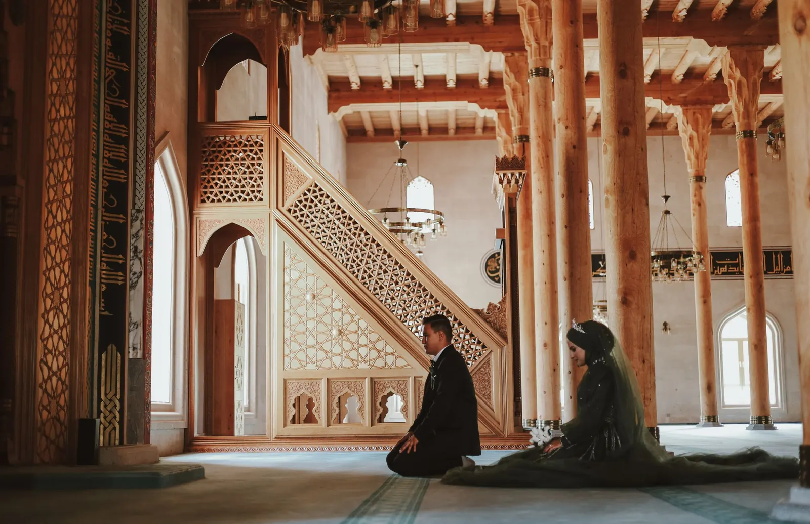 Newlywed couple kneeling in a mosque